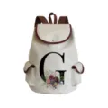 Detailed view of canvas backpack featuring floral letter G print and brown leather trim. - Letter G Print Style (sj2464)