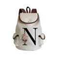 Canvas backpack detail showing custom floral letter N design and brown trim features. - Letter N Print Style (sj2471)