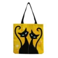 Detailed view of the retro style black cats print canvas tote bag with black handles. - Yellow Background Vintage Star Cat Print (hm9305)