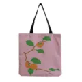 Detailed view of the pink canvas tote bag featuring a charming persimmon branch print and straps. - Persimmon Plant(hm6460)