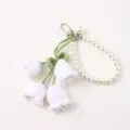 Handmade crochet lily of the valley keychain with elegant pearl strap and metal clasp fashion. - White