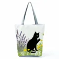 Detailed view of the black cat print canvas tote bag with lavender and dandelion pattern. - Black Cat and Lavender (hlk2475)