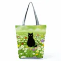 Black cat print canvas tote bag, detailed view of the cute floral pattern and sturdy straps. - Black Cat and Meadow Flowers (hlk2480)