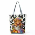 Highland cow floral print detail on canvas tote bag handle and zipper pocket design. - Cartoon Highland Cow Painting Style (hlk3328)