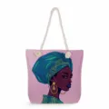Detailed view of the stylish pink canvas tote bag featuring an artistic African woman print. - Pink Fashion Portrait (msk3501)