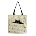 Close-up detail of the canvas tote bag featuring cute black cat and colorful musical notes. - Colorful Notes Cat (hmk2954)