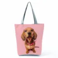 Cute dachshund dog print shoulder tote bag with solid pink background and sturdy grey handles. - Pink Background Dachshund Print (hl7370)