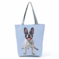Closeup of the cute French bulldog print pattern and grey handles on the blue tote bag. - Light Blue Background French Bulldog Print (hl7371)