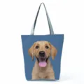 Close-up detail of the cute golden puppy print on the blue fabric tote bag surface clearly. - Blue Background Puppy Head Print (hl7374)