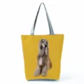 Detailed close-up of the stylish printed tote bag showcasing the cute dog pattern and sturdy handles. - Yellow Background Long-haired Hound Print (hl7377)