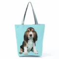 Close-up detail of the cute beagle puppy print and durable grey handles on this casual tote bag. - Light Blue Background Beagle Print (hl7381)