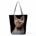 Closeup detail of the large capacity black tote bag featuring a realistic cat print and grey straps. - White Cat on Black Background Print (hl5096)
