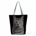 Close-up detail of the realistic tabby cat print on the stylish black tote bag fabric. - Tabby Cat Print (hl5098)