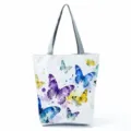 White canvas tote bag featuring colorful watercolor butterflies and grey handles for daily use. - Shoulder Tote Style (hlk2710)