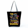 Detail view of the black canvas tote bag showcasing the colorful teachers return to school print. - Style Ten (hl5398)