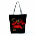 Detailed view of a fashionable black tote bag featuring stunning red and yellow butterfly prints. - Shoulder Tote Style (hlk2717)