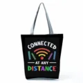 Detail view of the canvas tote bag featuring teacher theme graphic print and sturdy straps. - Style Nineteen (hl5407)