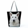 Close-up of black canvas tote bag featuring realistic white dog print and double handles. - White Dog Print (hl5115)