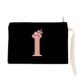Detail view of black canvas makeup pouch featuring pink initial letter and floral print wrist strap. - Letter I Style (xbk2870)