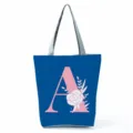 Blue floral letter A canvas tote bag, large capacity casual shoulder bag for daily use. - Letter A