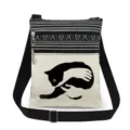 Close-up detail of the black cat printed canvas crossbody bag with double zippers and strap. - Style (xk2498)