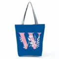 Blue canvas tote bag with pink letter W and floral print, stylish daily shoulder bag. - Letter W