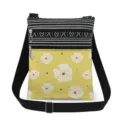 Detail shot of small crossbody bag featuring dual zippers and adjustable black shoulder strap. - Yellow With White Floral (xk12531)