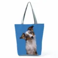 Close-up detail of the cute dog print canvas tote bag with comfortable grey shoulder straps. - Blue Background Cute Shepherd Print Style (hl7393)
