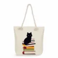Close-up view of the canvas tote bag featuring a cute black cat and books print detail. - Black Cat With Retro Floral Style (msk2477) / 45x35x12cm