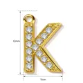 Gold letter K pendant detail showing 12mm height and 7mm width with sparkling cubic zirconia. - Letter K