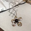 Collana girocollo a catena serpente in metallo argentato con ciondolo floreale irregolare. - 39# Collana-Argento