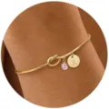 Bracciale rigido dorato con nodo, ciondolo pietra portafortuna rosa e lettera X - X (Lettera X) / Gennaio (Pietra di Nascita Rosa) / Oro