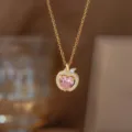 Elegant 18K gold plated apple pendant necklace featuring a sparkling pink heart crystal stone - Apple Necklace with Pink Rhinestones (Gold-Tone)