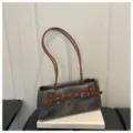 Grey denim shoulder bag with brown straps and stylish belt buckle design for casual daily use. - Contrast Black
