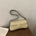 Woven baguette shoulder bag for women, stylish underarm purse with vintage gold lock clasp. - Black