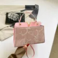 Stylish pink shoulder bag for women, summer commuter handbag with elegant V metal logo. - Pink