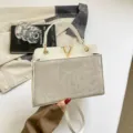 Chic minimalist white shoulder bag for women, stylish summer commuting handbag with metal V decor. - White