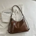 Brown PU leather shoulder tote bag with front zipper pocket and elegant pearl bow accent. - Brown