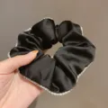 Elegant black satin hair scrunchie featuring sparkling rhinestone edge design for women daily use. - Rhinestone Scrunchie / Black