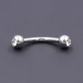 Closeup detail of stainless steel curved barbell eyebrow ring with sparkling crystal gems. - 1.2*8*3mm / White