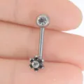 Primo piano dettagliato di piercing ricurvo in titanio con design floreale scintillante. - Stile Fiore Nero / 1.6*11*5mm / Nero
