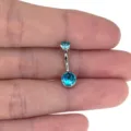 Detail shot of G23 titanium belly button ring featuring sparkling blue zircon on bar. - 1.6x6x5x8mm / Silver Aquamarine Rhinestone