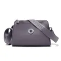 Stylish grey purple nylon crossbody shoulder bag with wide strap and metallic logo accent. - Purple