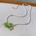 Elegant pearl necklace featuring green crystal flower pendant and gold-tone chain details. - 07# Artificial Pearl Necklace Green Crystal Real Gold