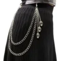 Close-up of multi-layer punk metal waist chain with skull pendants on black skirt. - Skull Double Layer Pant Chain