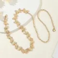 Close-up of gold butterfly chain belt detail, elegant metal waist jewelry for dresses. - Butterfly / Gold