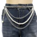 Close-up detail of multi-layered silver chain and faux pearl waist belt on denim. - Silver