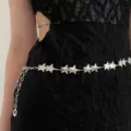 Close-up detail of a silver star metal waist chain accessory, sparkling body chain. - 12 Pairs Star Waist Chain / Silver