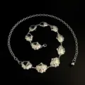 Silver tone metal shell waist chain detail, featuring delicate seashell pendants and links. - Shell Waist Chain / Silver