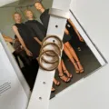 White women belt featuring striking gold ring buckle, stylish minimalist accessory detail view - White